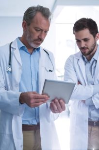 doctors-having-discussion-over-digital-tablet-in-c-2021-08-28-22-13-08-utc-Custom.jpeg